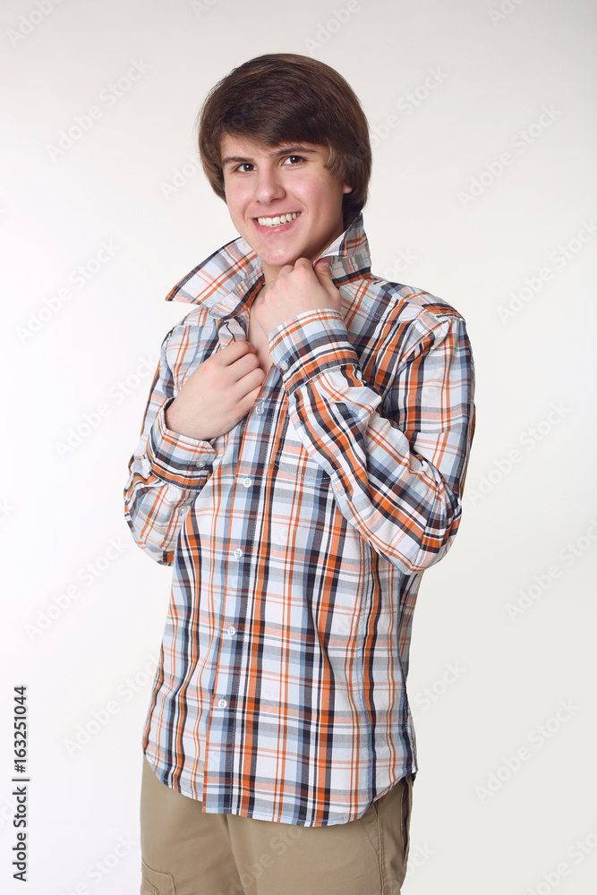 Cheerful Man in checked shirt and smart casual wear looking at camera. Handsome guy in street clothes isolated on studio white background. Cheerful Man in checked shirt and smart casual wear looking at camera. Handsome guy in street clothes isolated on studio white background.