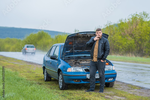 Alarmed driver tries to repair the car