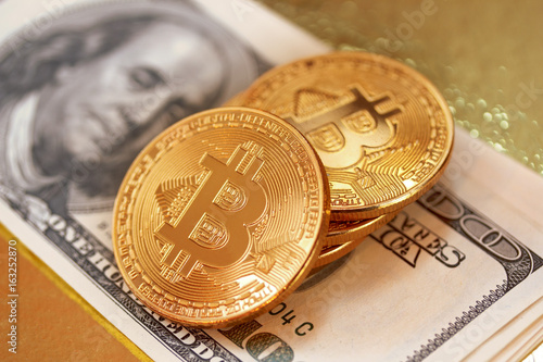 Golden bitcoin on a gold background photo