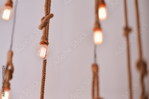 Electric lamps hanging on a rope photo
