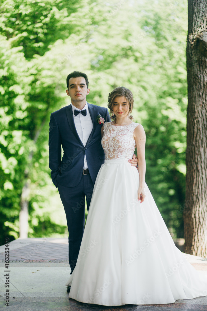 Happy bride and groom spending time in the park Happy bride and groom spending time in the park