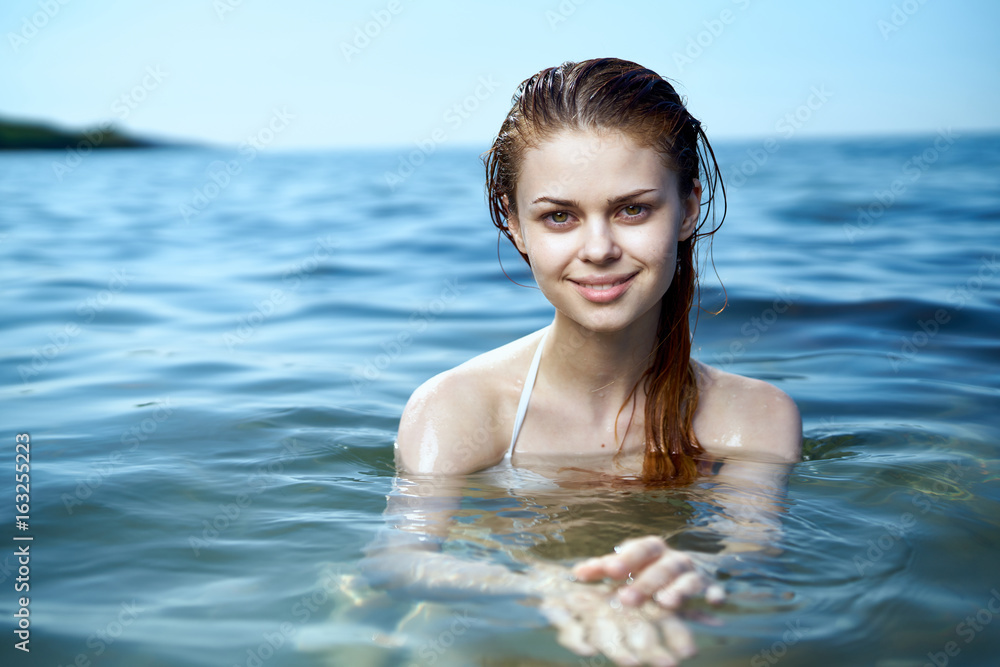 1122447 Beautiful young woman is resting on the sea, ocean, summer, sun, beach