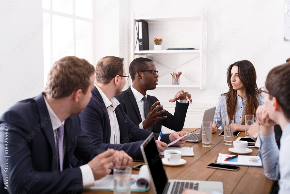 Business meeting. Young team in modern office Business meeting. Young team in modern office