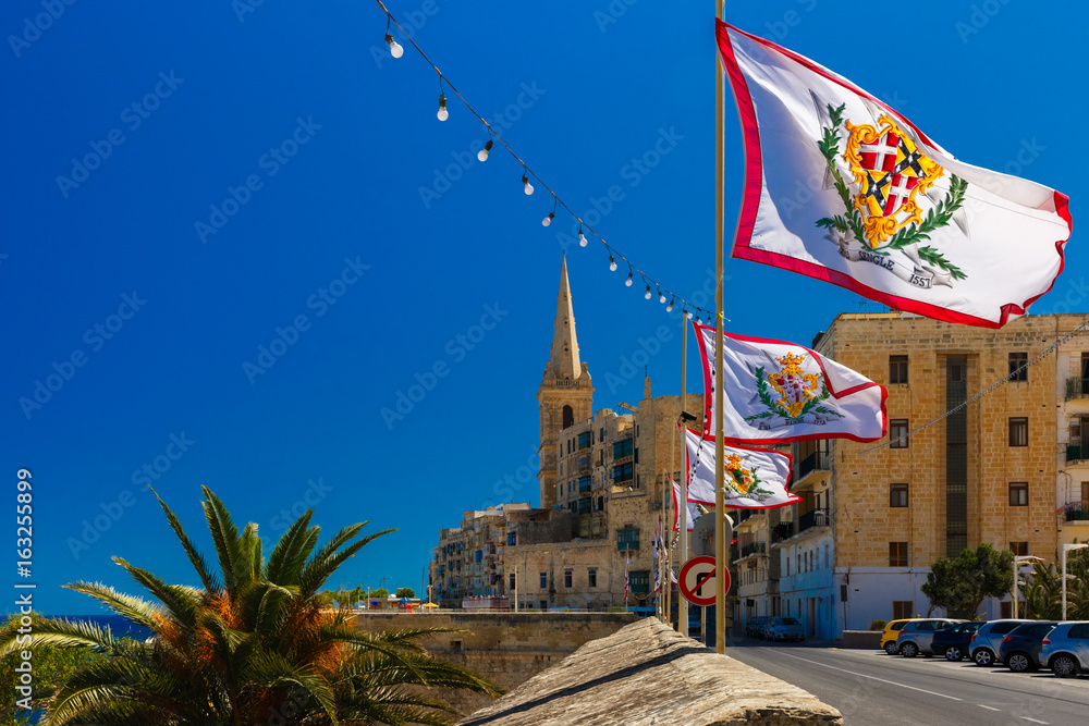 Festively decorated street with flags of all the Grand Masters of the
