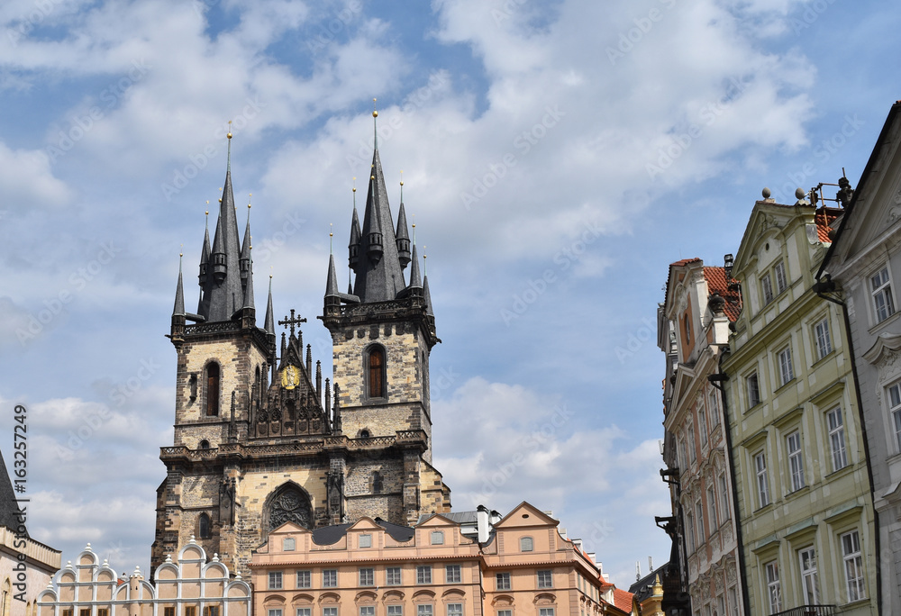 Church of Mother of God before Týn or Church of Our Lady before Týn in the Old Town Square in Prague, Czech Republic, with blue sky and white clouds in the background.