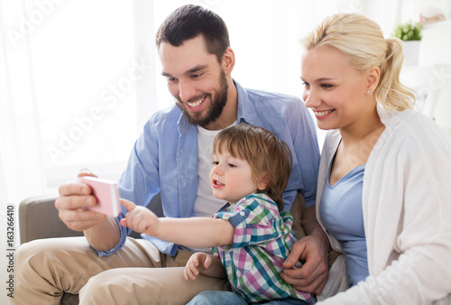 happy family with smartphone at home