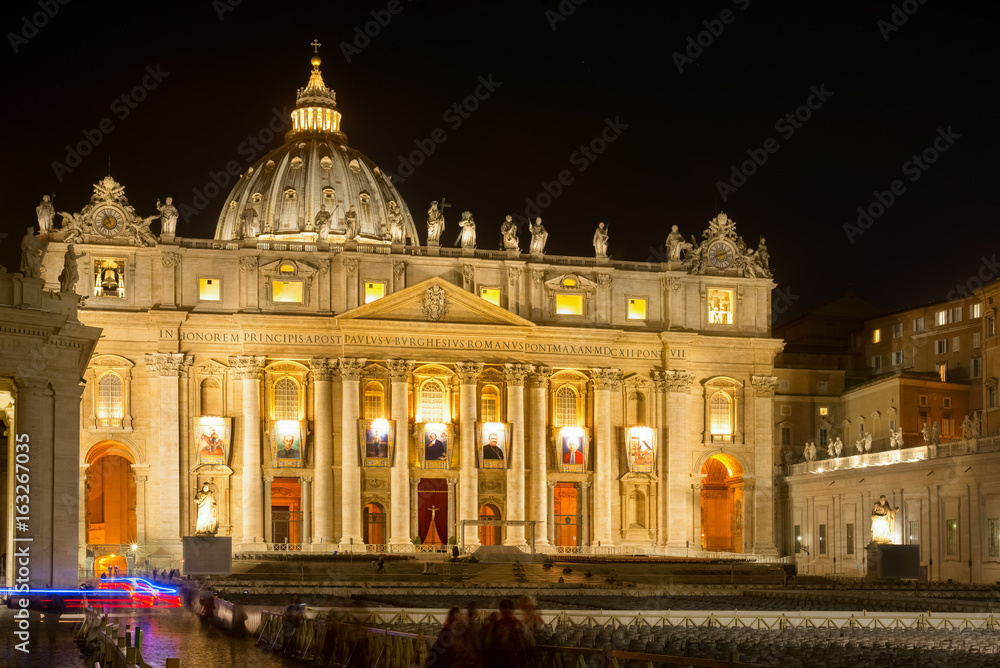 Incredible lateral view on the illuminated Saint Peter's basilica, Vatican Italy