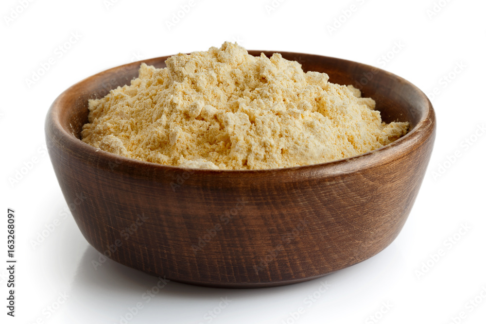 Chickpea flour in dark wooden bowl isolated on white. Chickpea flour in dark wooden bowl isolated on white.