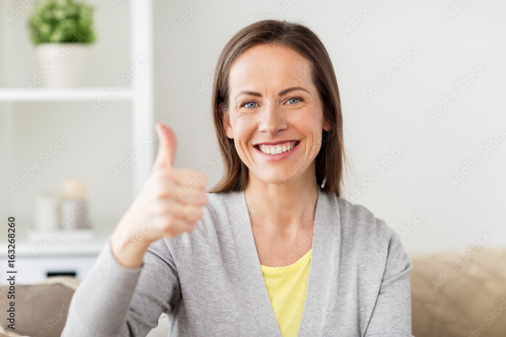 happy smiling woman showing thumbs up at home happy smiling woman showing thumbs up at home