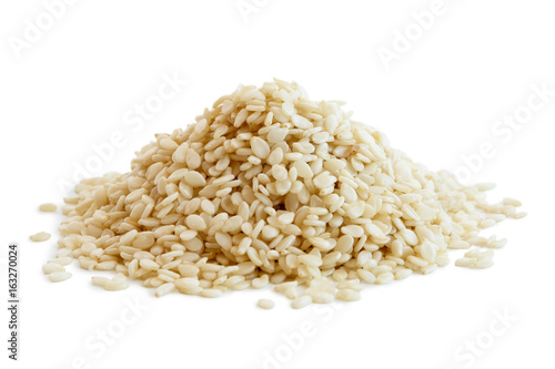 Heap of decorticated sesame seeds isolated on white. photo