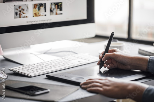 Hands of cropped unrecognisable woman graphic designer working with pen tablet. photo