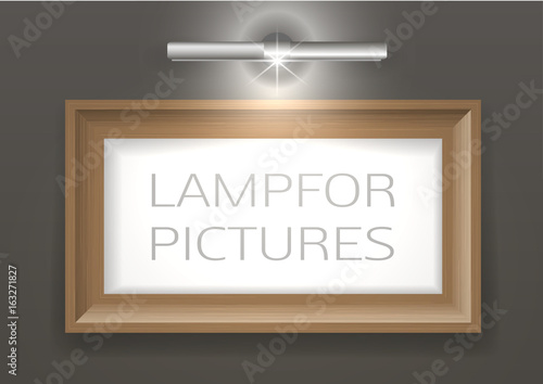 Lamp for a picture and a picture in a wooden frame on the wall. Light with transparency effect