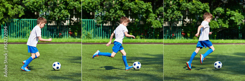 Boy football player running with ball on green lawn