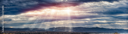 Beam of light through the clouds on the mountains - Rays of light shining thr...