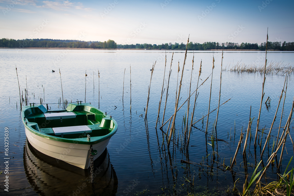Rowing boat floating over the Lake Selment Wielki waters. Masuria, Poland.