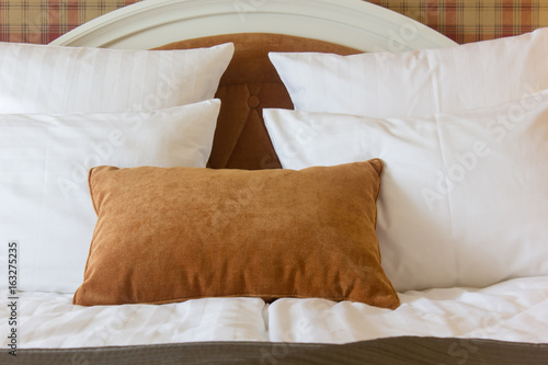 Pillows on bed in hotel roo...