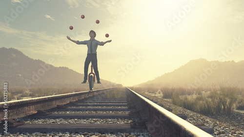 Juggler is balancing on railroad photo