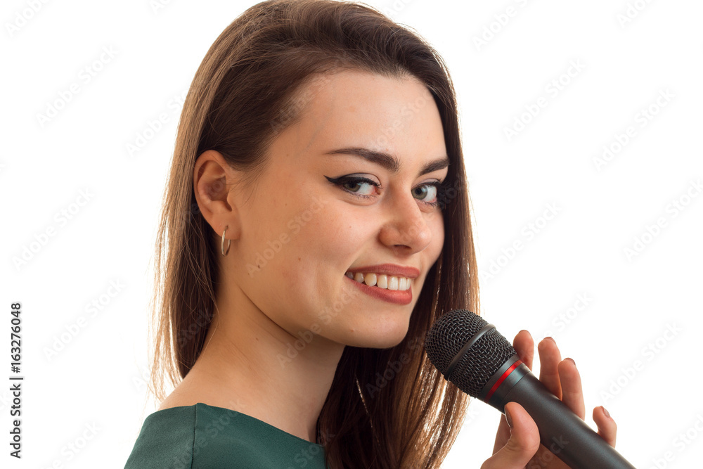 close-up portrait of a remarkable young girl who is smiling and holding a microphone close-up portrait of a remarkable young girl who is smiling and holding a microphone