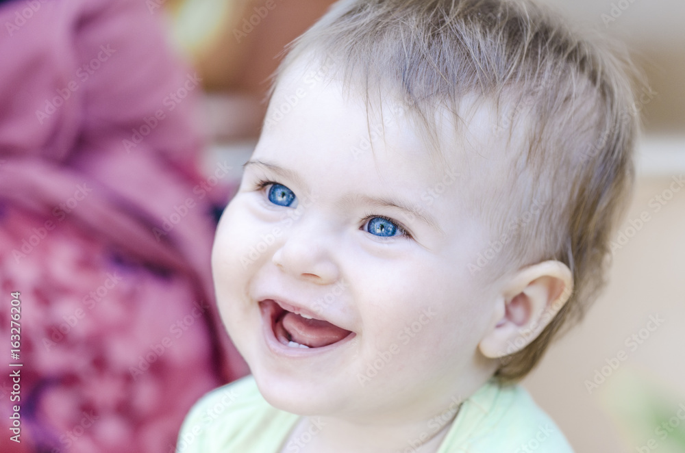 Closeup of happy baby smiling with her first teeth Closeup of happy baby smiling with her first teeth