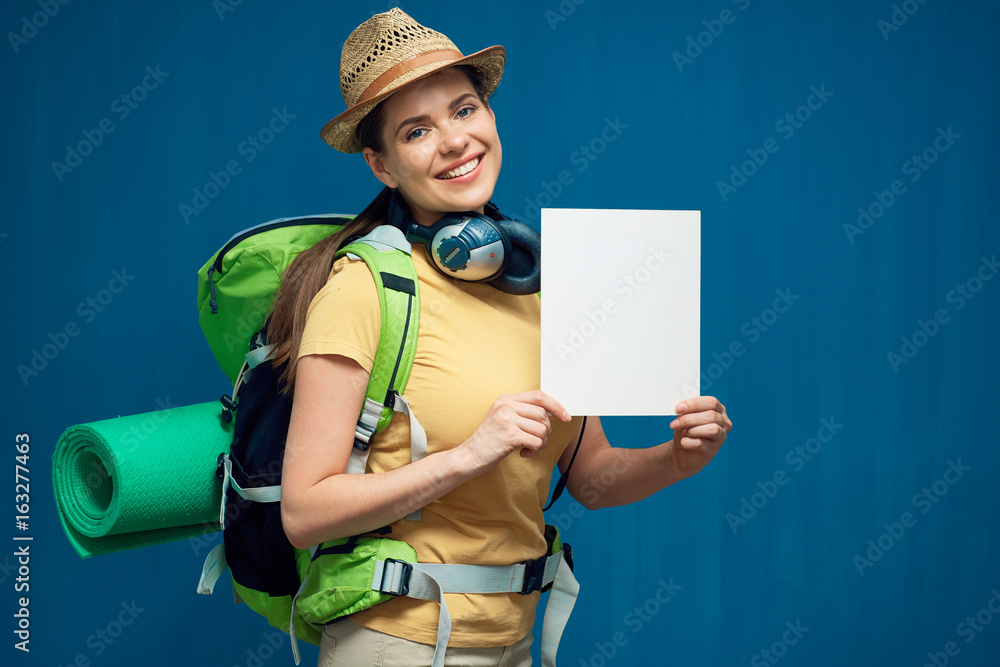 Smiling woman tourist holding white board with copy space Smiling woman tourist holding white board with copy space