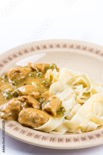 White chicken meat with sauce on the plate in closeup macro.