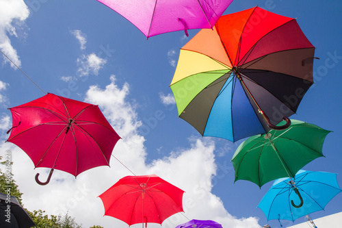 Colorful umbrellas against the sky - a street decoration