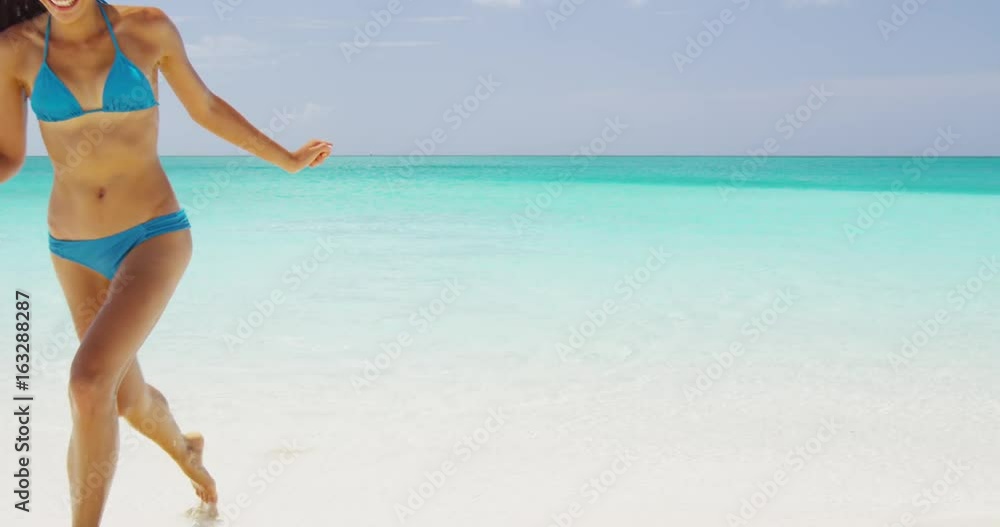 Beach bikini woman running out of sea laughing happy after swimming in the ocean on vacation travel getaway holidays. Beautiful young multiracial Asian Caucasian female model. RED EPIC SLOW MOTION, Beach bikini woman running out of sea laughing happy after swimming in the ocean on vacation travel getaway holidays. Beautiful young multiracial Asian Caucasian female model. RED EPIC SLOW MOTION,