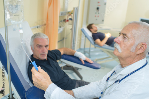 Doctor adjusting patient s drip