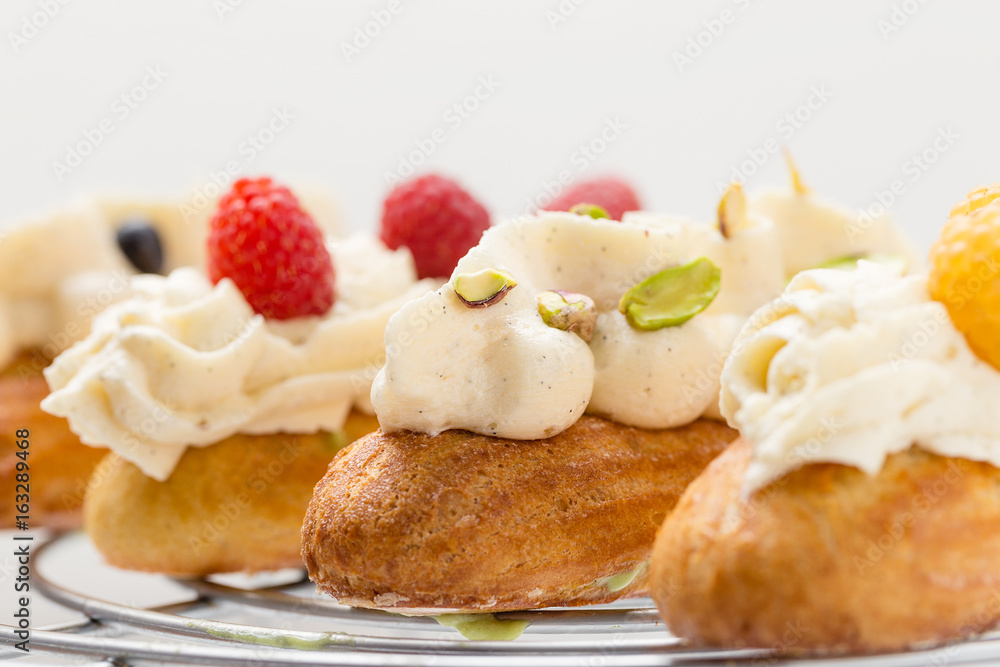 Eclair with vanilla cream and pistachio Eclair with vanilla cream and pistachio