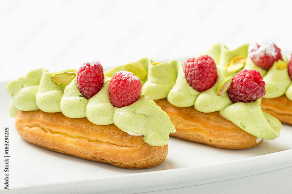 Eclaire with pistachio cream and strawberries Eclaire with pistachio cream and strawberries