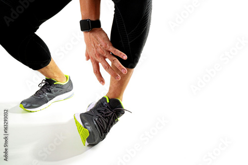 Foto Runner sportsman holding ankle in pain with Broken twisted joint running sport i