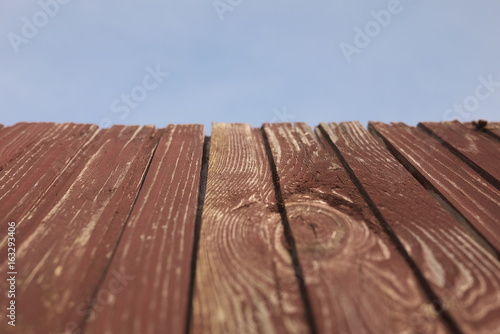 Red old wood textured background with blue sky