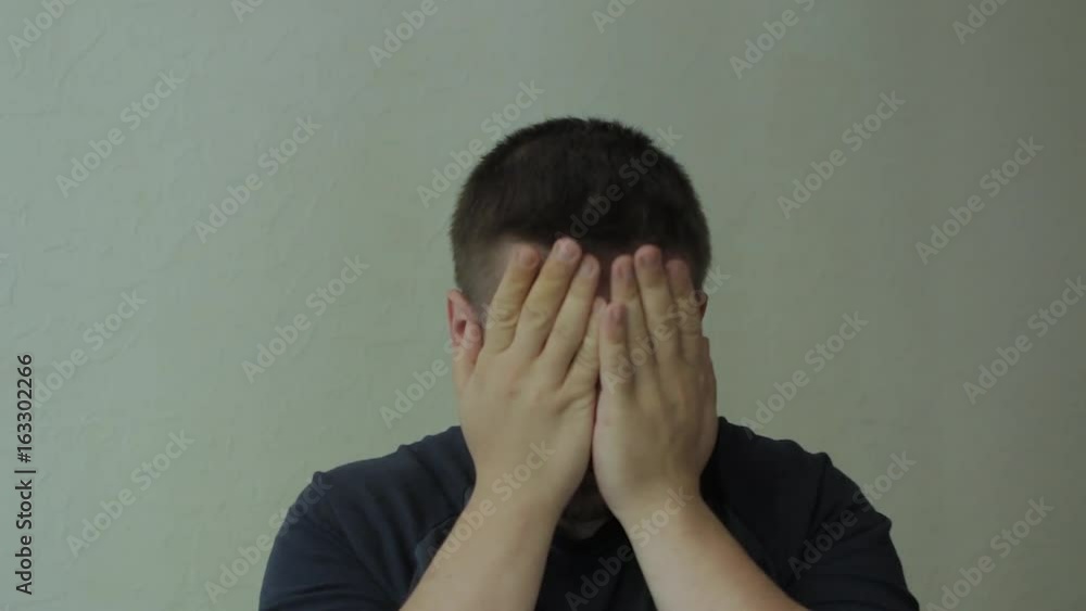 Tired man rubbing his face and eyes. Tired man rubbing his face and eyes.