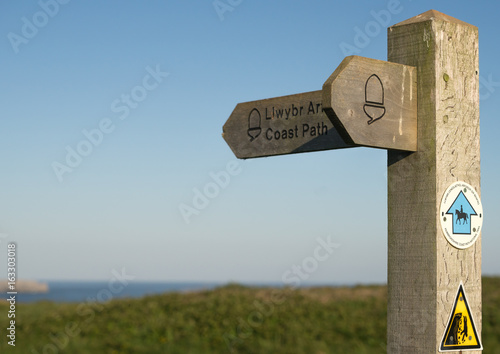 Pembrokeshire coast path sign with a clear blue sky and potential copy space