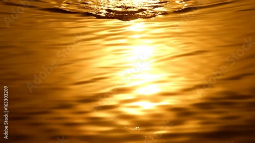 Man swimming at sunset background