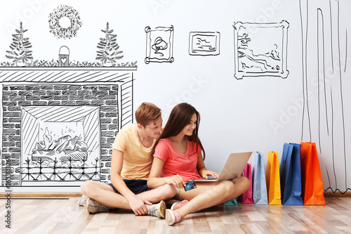 Happy couple with laptop an...