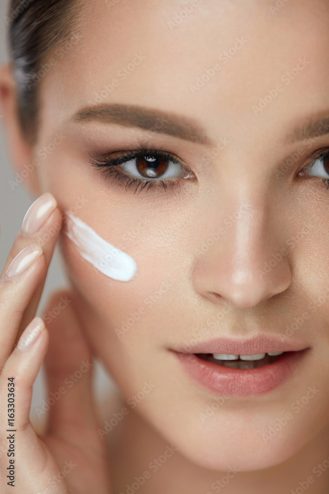 Beauty Cosmetics. Sexy Girl Face With Cosmetic Cream On Skin Beauty Cosmetics. Sexy Girl Face With Cosmetic Cream On Skin