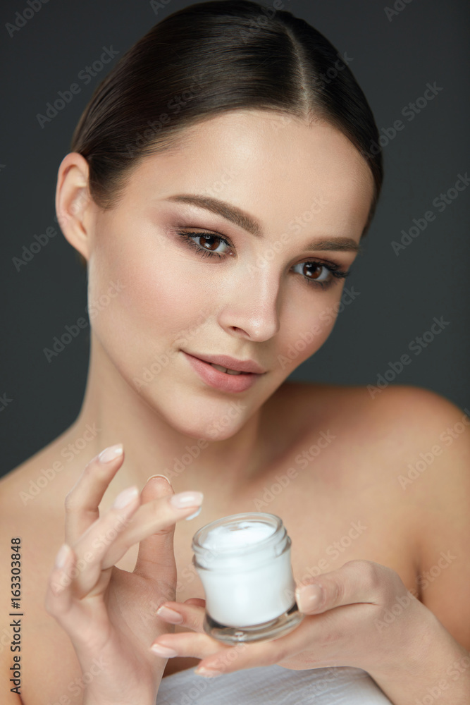 Face Beauty Care. Woman With Natural Makeup Holding Cream Face Beauty Care. Woman With Natural Makeup Holding Cream