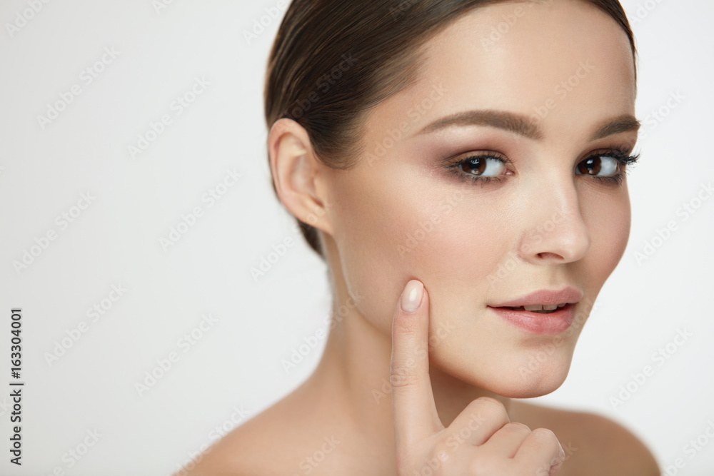 Woman Skin Beauty. Girl With Natural Makeup Touching Skin