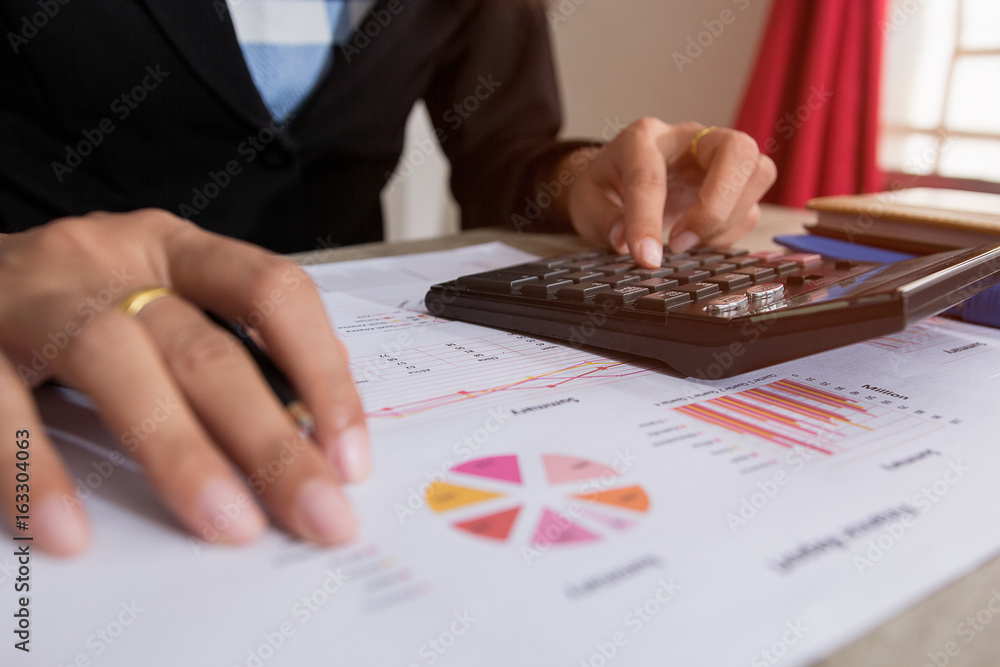 Businessman check profit document and calculate about and note data cost at home ,Finance managers task,Concept business and finance Businessman check profit document and calculate about and note data cost at home ,Finance managers task,Concept business and finance