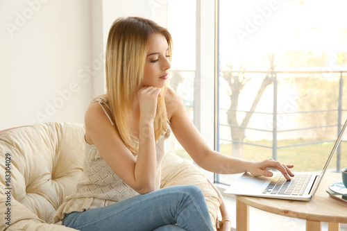 Young girl using laptop in ...