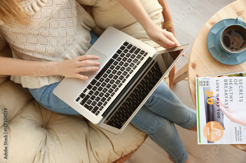 Young girl using laptop in ...