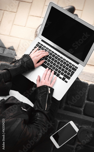 Young girl using laptop out...