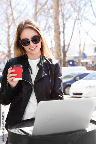 Young girl holding cup of c...