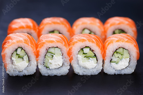 Canvas Print Tasty and fresh philadelphia sushi rolls served on black slate, close up