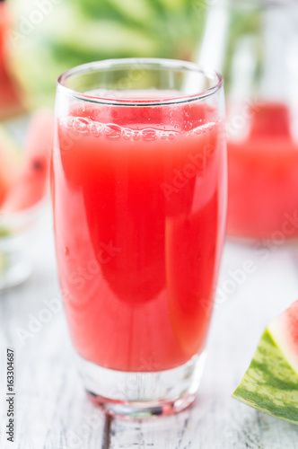Wooden table with Watermelon Smoothie (selective focus)