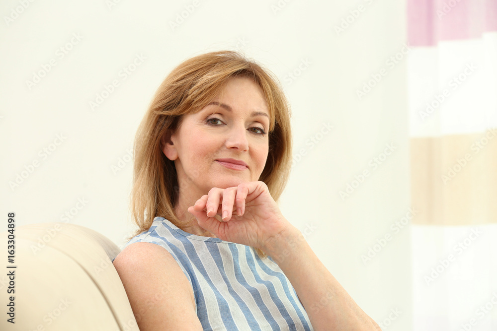 Attractive mature woman resting on sofa at home Attractive mature woman resting on sofa at home