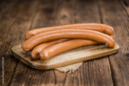 Wooden table with Wiener Sausages (selective focus)