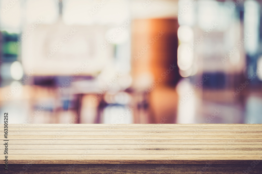 Empty wooden table with restaurant blur background - can be used for display your products.