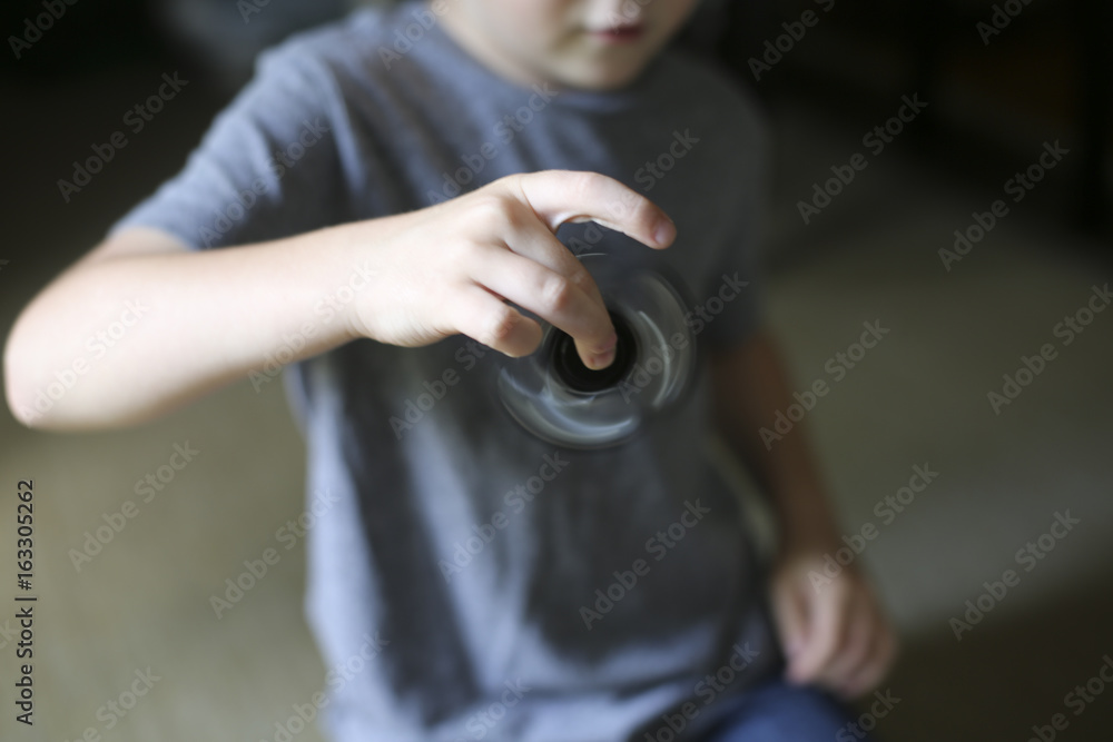 Little Boy Playing with a Fidget Spinner